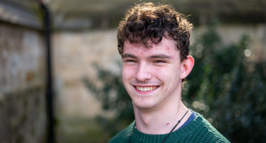 Male student smiling to camera