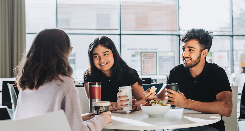 3 students eating nachos