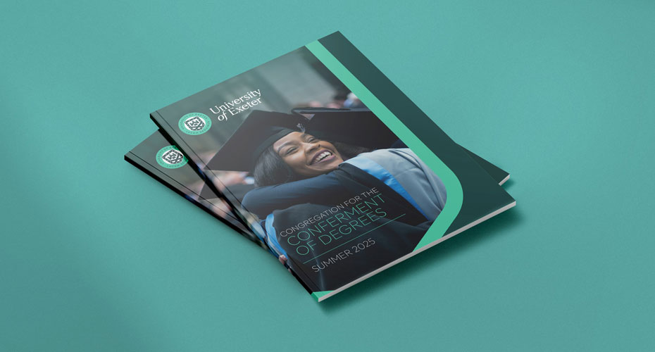 Picture of the graduation brochure for 2025 sitting in a blue table.